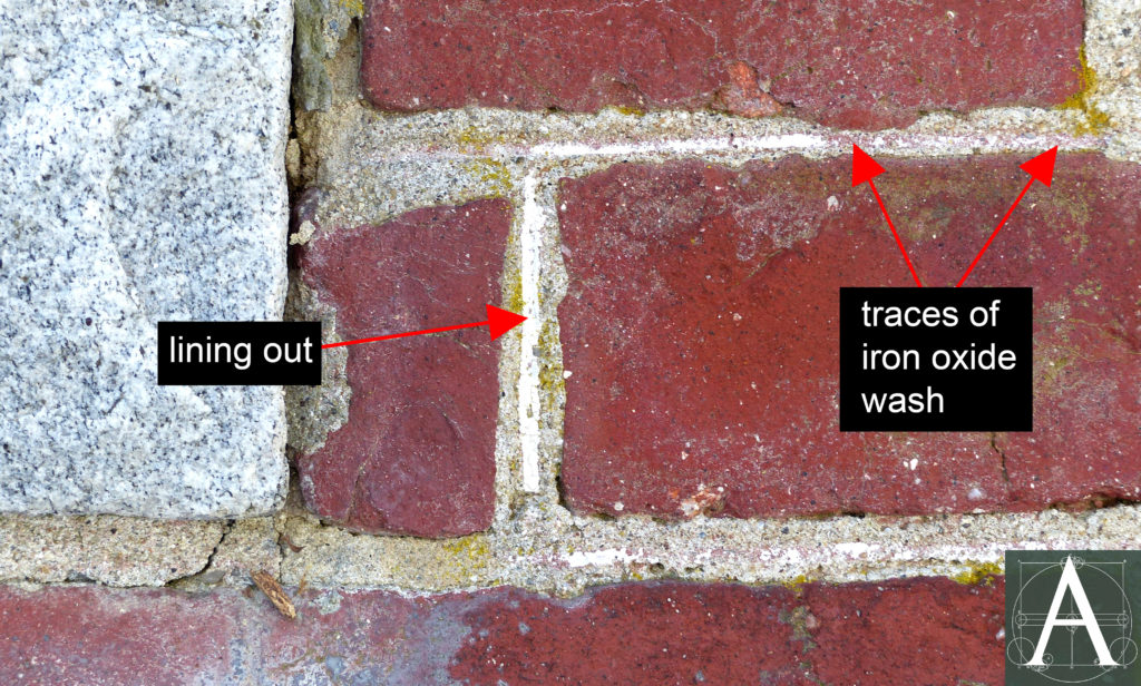 detail of brickwork showing remains of original iron oxide wash and mortar joints lined out in white