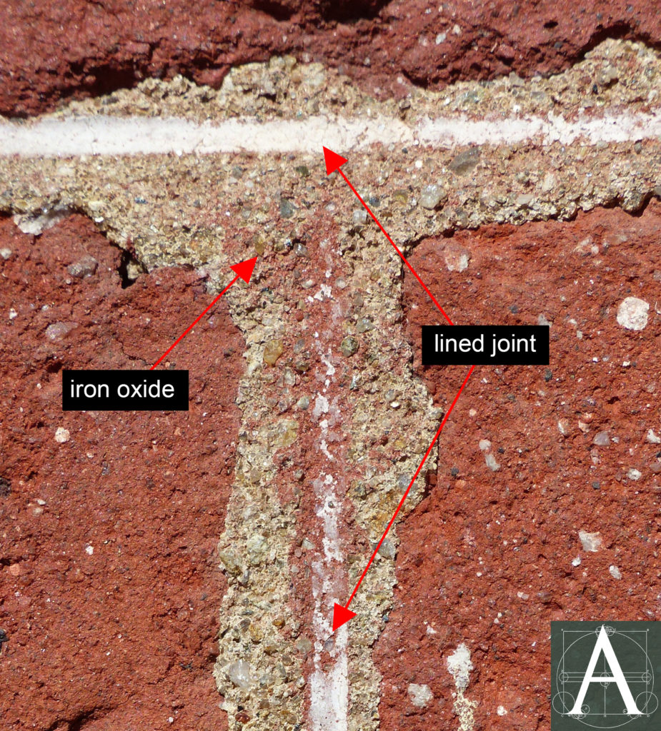 close-up view of masonry showing iron oxide wash applied as base layer before lining-out of joints