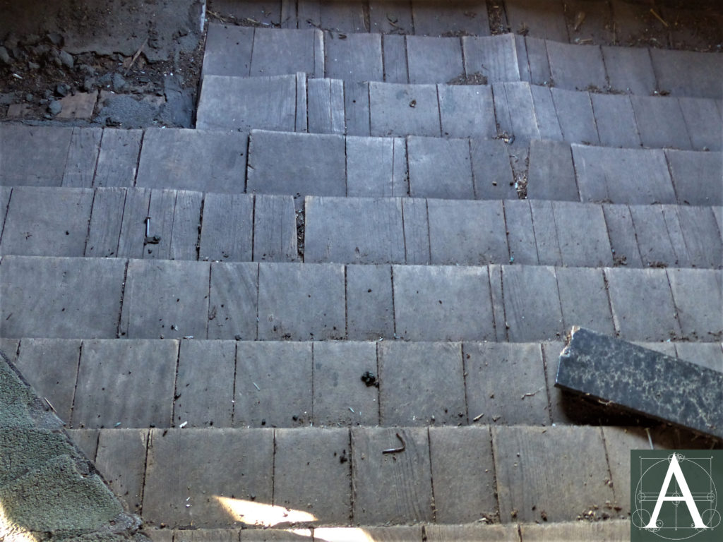 Low hipped roof at the bell-landing with original wooden shingles (1862) and added asphalt shingles at the ridges (1960) - lower left of photograph