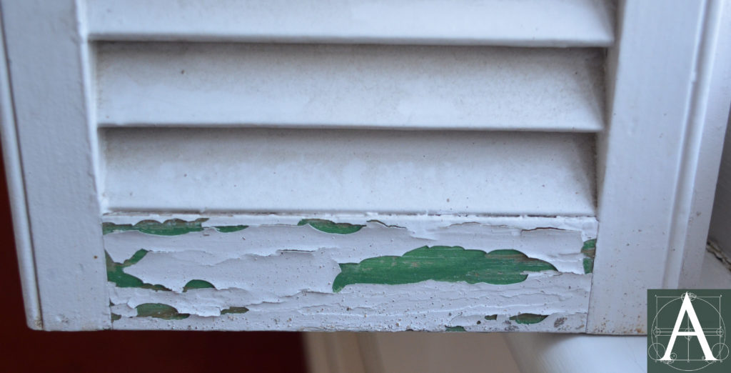 Original interior shutter showing its original green paint beneath the current paint
